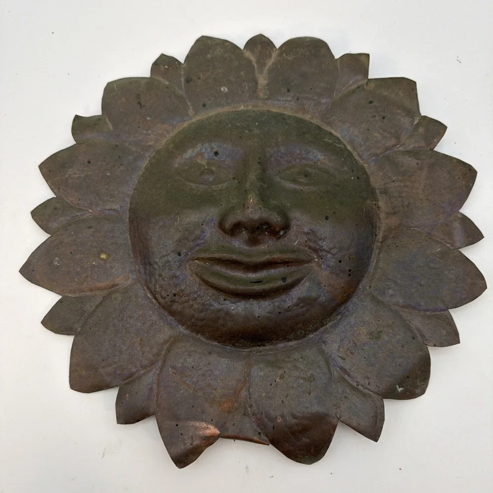 vintage sun wall plaque made of hammered copper sheet metal.
